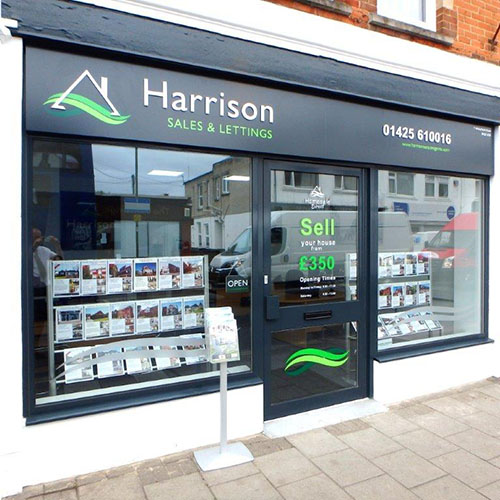 Harrison Estate Agent frontage showing combi ladder window displays